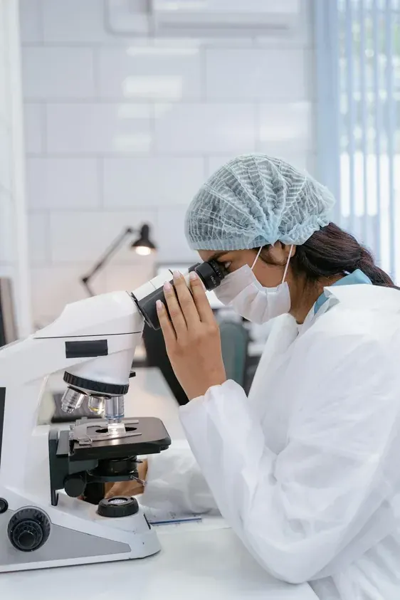 Medical professional using a microscope in a modern laboratory