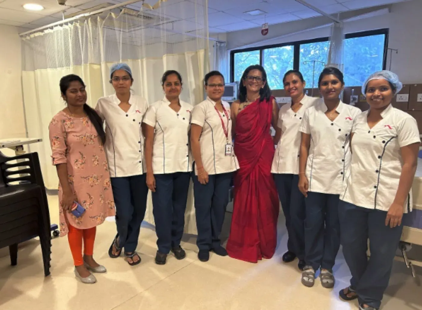 Dr. Mona Shroff standing with her care team in the clinic