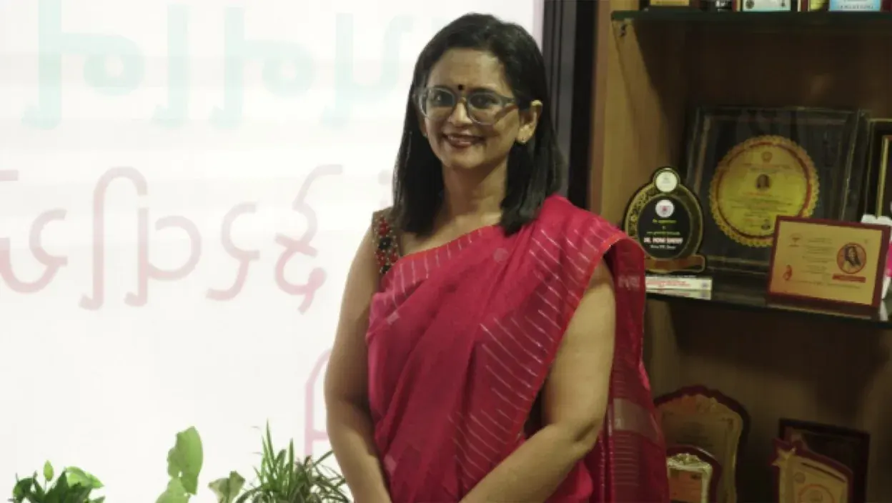 Dr. Mona Shroff in a formal portrait with awards in the background