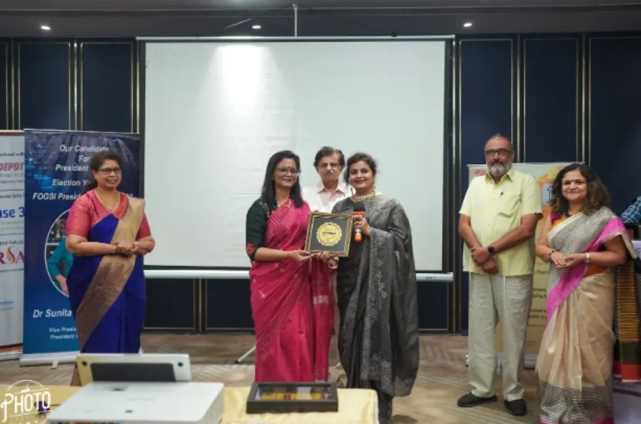 Dr. Mona Shroff receiving recognition at an event